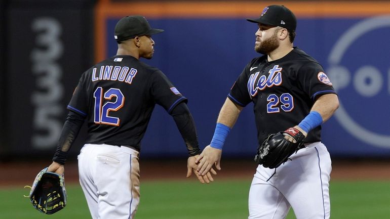 Francisco Lindor and DJ Stewart of the Mets celebrate after defeating...