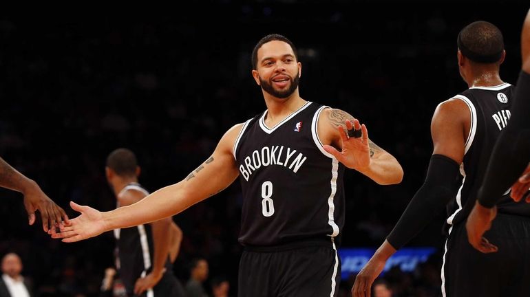 Deron Williams smiles after a play against the Knicks during...