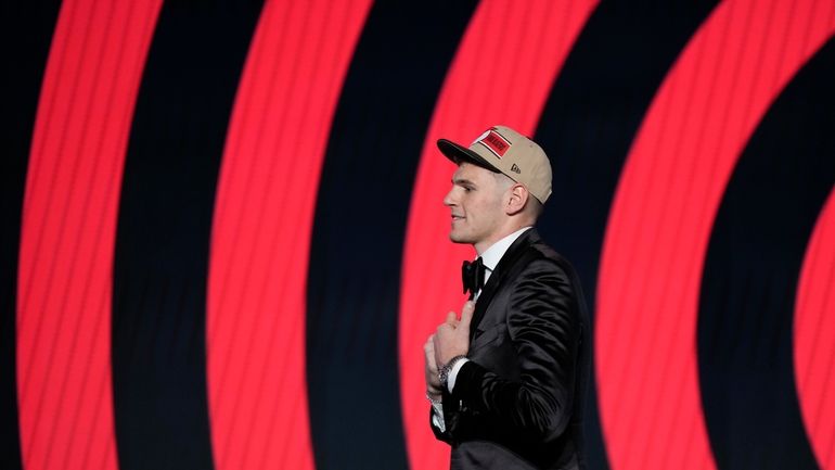 Donovan Clingan walks across the stage after being selected by...