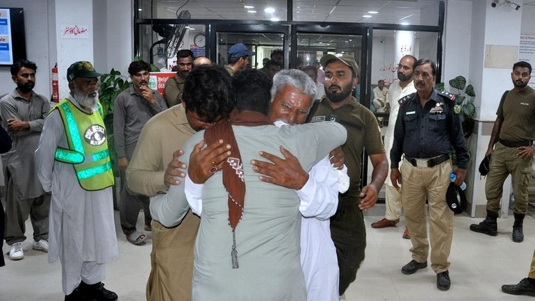 Family members of police officers, who were killed in gunmen...