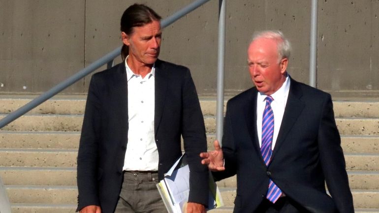 Montauk fisherman Christopher Winkler, left, confers with his lawyer, Peter...