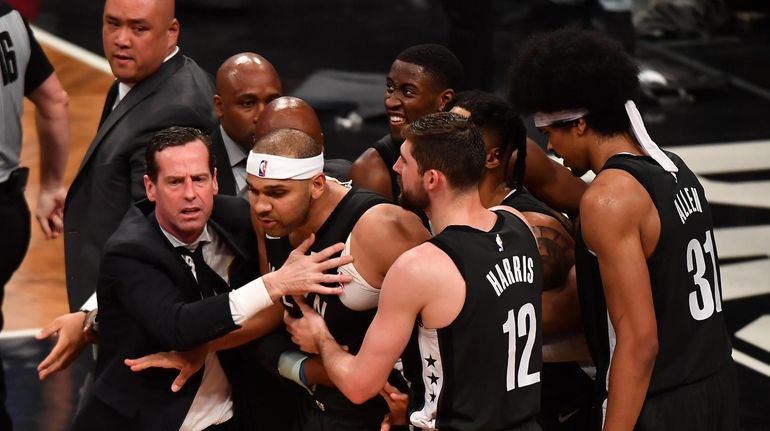 Nets head coach Kenny Atkinson grabs Nets forward Jared Dudley...