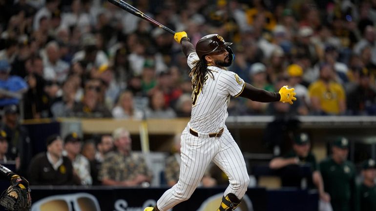 San Diego Padres' Fernando Tatis Jr. watches his home run...