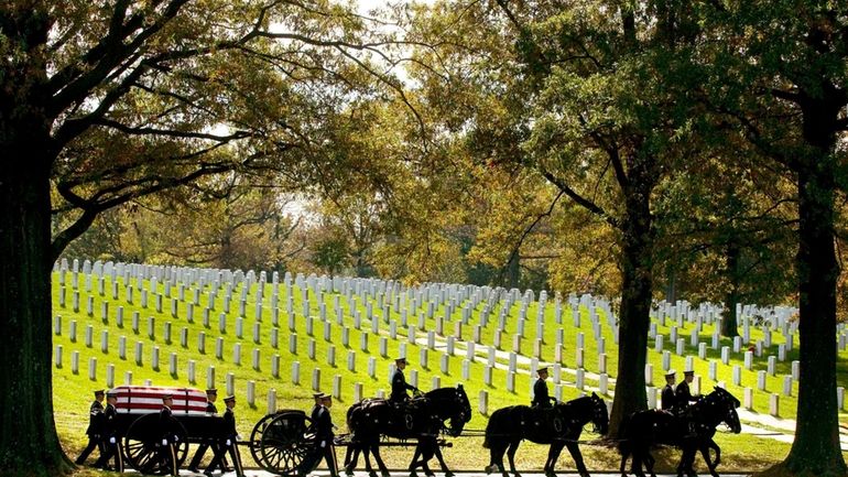 A U.S. Army Caisson team carries the remains of Army...