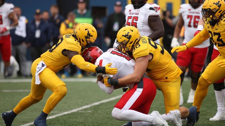 Texas Tech quarterback Tyler Shough (12) is sacked West Virginia's...