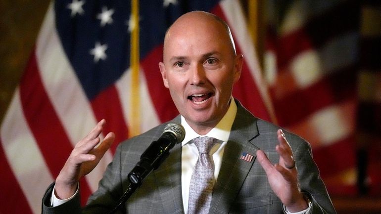 Utah Gov. Spencer Cox speaks during a news briefing during...