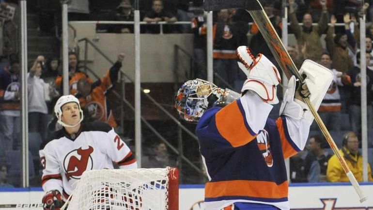 Islanders goalie Rick DiPietro celebrates after time expired in his...