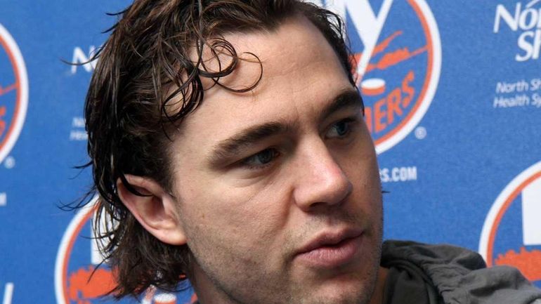 P.A. Parenteau talks to reporters before making his exit as...