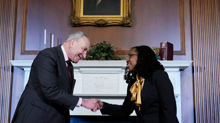 Senate Majority Leader Chuck Schumer of New York shakes hands...