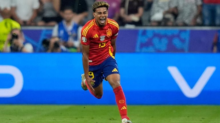 Spain's Lamine Yamal celebrates after scoring his side's first goal...