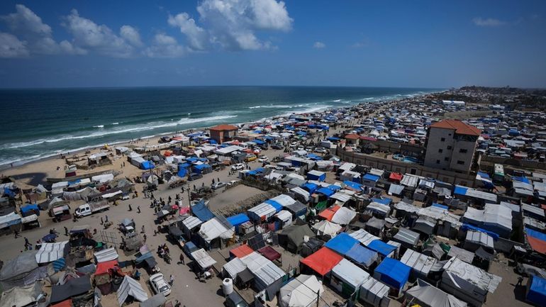 Palestinians displaced by the Israeli air and ground offensive on...