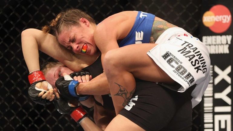 Liz Carmouche attempts to submit Ronda Rousey during their women's...