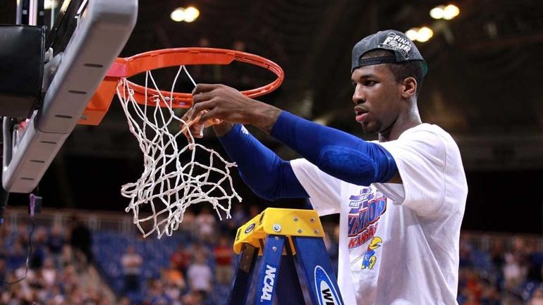 Thomas Robinson #0 of the Kansas Jayhawks cuts down a...