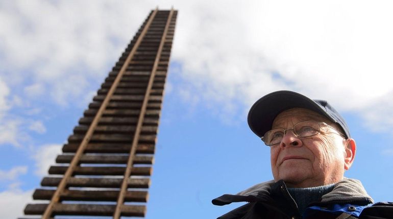 Czech sculptor Ales Vesely stands in front of his sculpture...