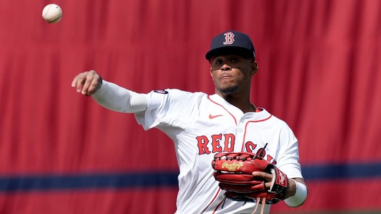 Boston Red Sox's Ceddanne Rafaela warms up before an opening-day...