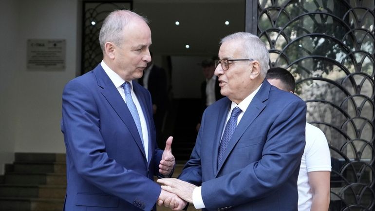 Lebanese Foreign Minister Abdallah Bouhabib, right, shakes hands with Ireland's...