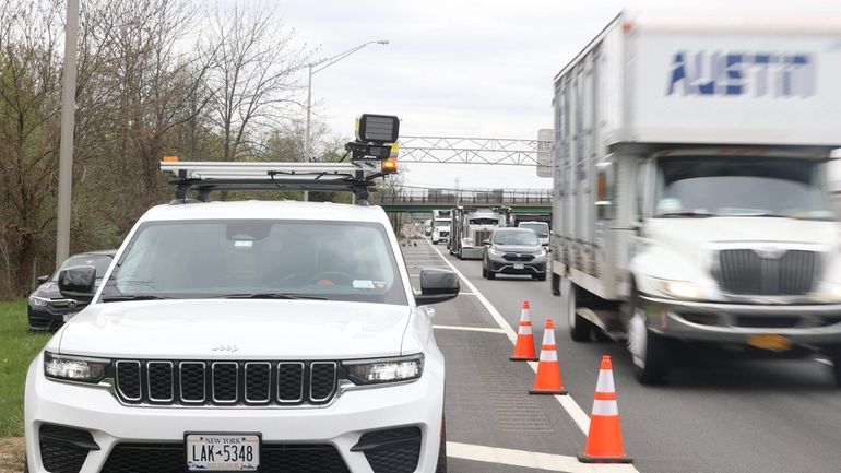 Speed cameras, like those mounted on an SUV along the eastbound...