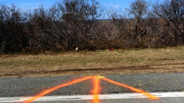 A painted arrow in the roadway of Ocean Parkway marks...