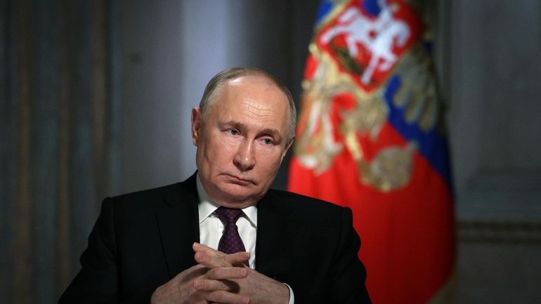 Russian President Vladimir Putin gestures while speaking during an interview...