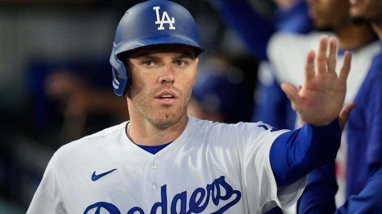 Los Angeles Dodgers' Freddie Freeman (5) returns to the dugout...