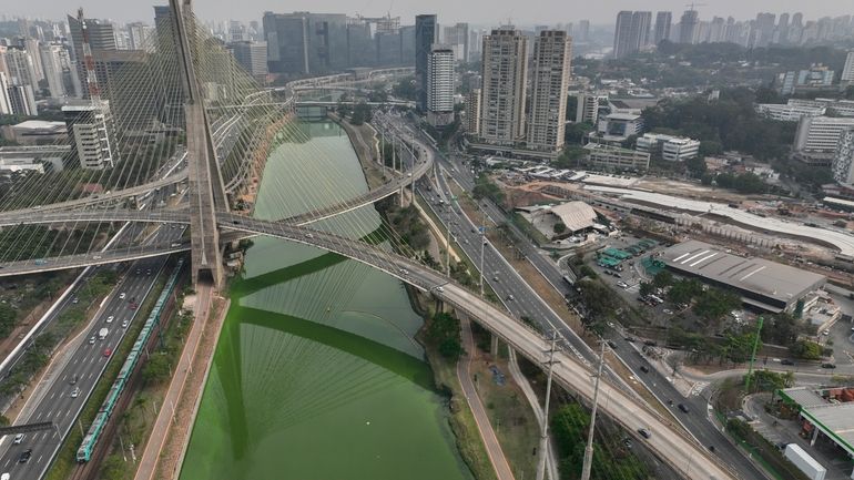 The Pinheiros River is green in Sao Paulo, Brazil, Tuesday,...