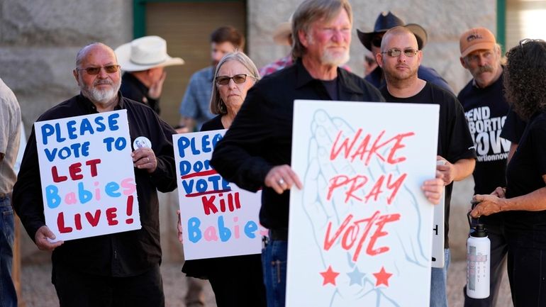 Anti-abortion supporters stand outside at the Arizona capitol, May 1,...