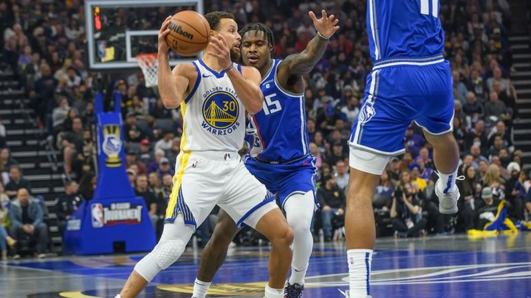 Golden State Warriors guard Stephen Curry (30) is guarded by...