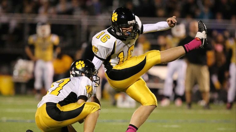 Commack placekicker Billy Holscher kicks the winning field goal in...