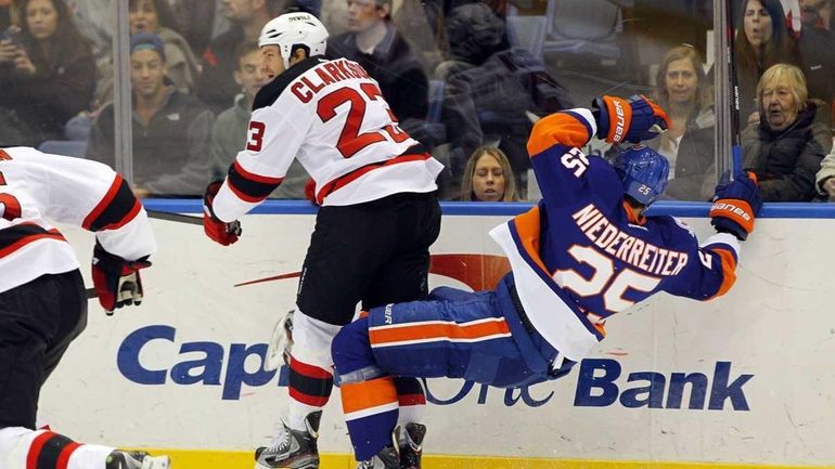 David Clarkson of the New Jersey Devils checks Nino Niederreiter...