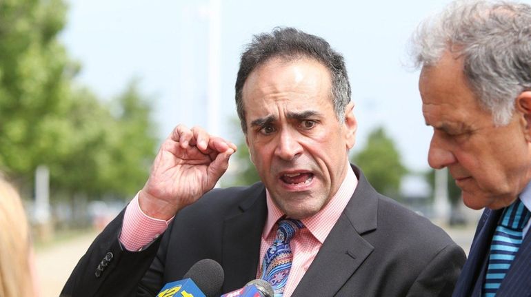 Dr. Michael Belfiore speaks to the media outside the federal...