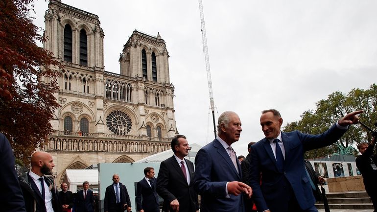 Britain's King Charles III, second right, pays a visit to...