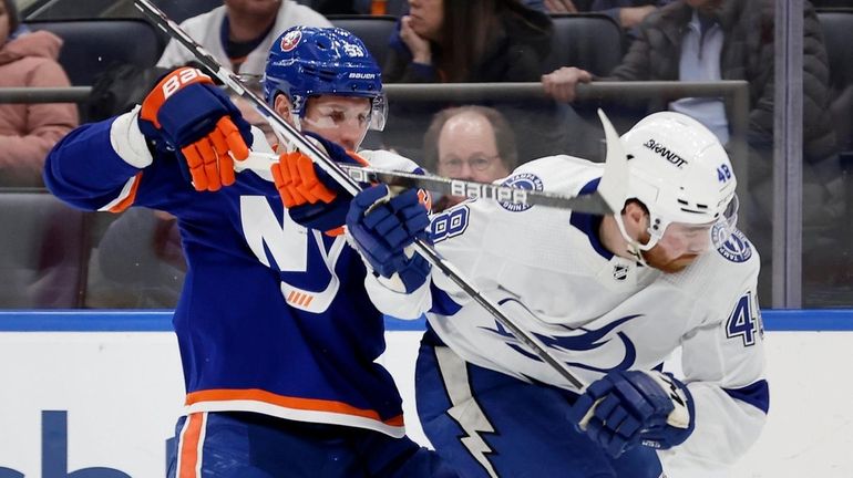 Casey Cizikas of the New York Islanders defends against Nick...