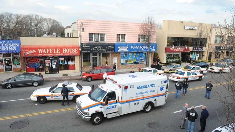 Police investigate the scene at Charlie's Family Pharmacy in Seaford,...