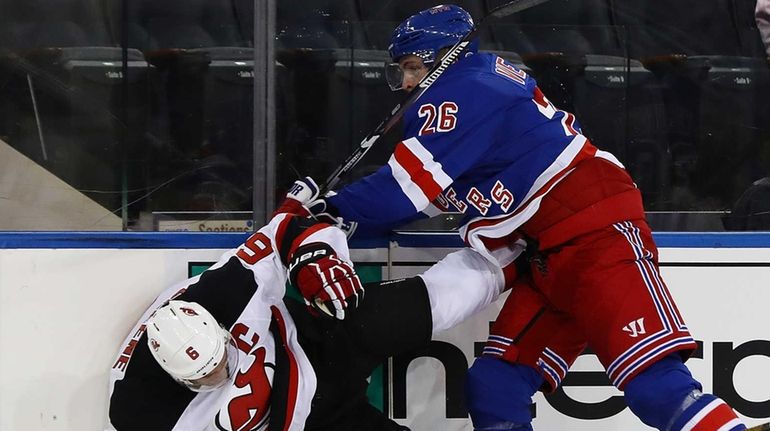 Jimmy Vesey #26 of the New York Rangers checks Andy...