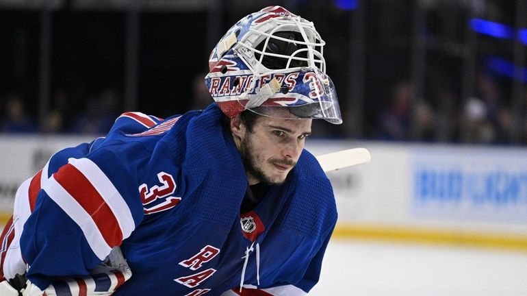 Rangers goaltender Igor Shesterkin skates to the net after a...