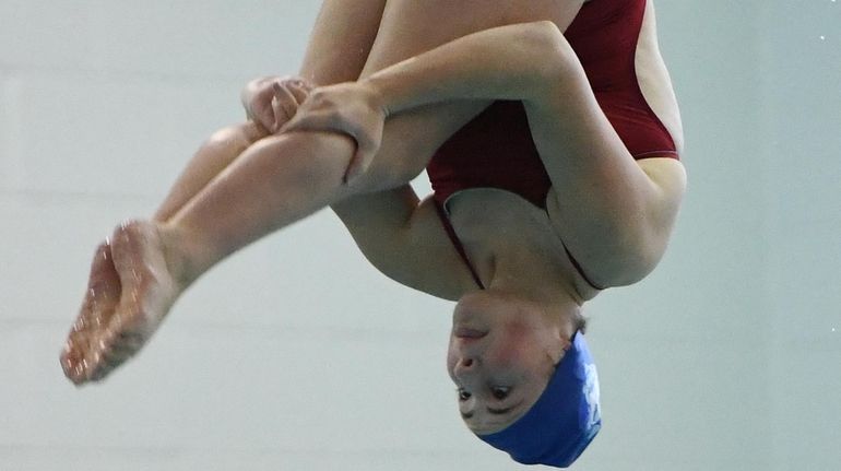 Patricia Arceri of Huntington executes a dive during the Suffolk...