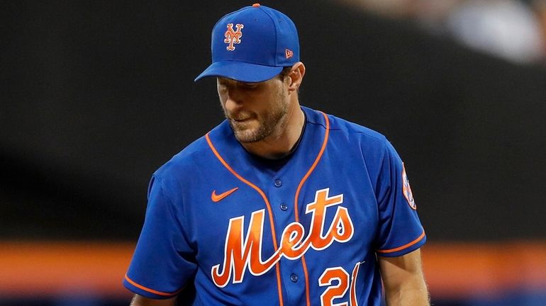 Max Scherzer of the Mets looks on during the first...