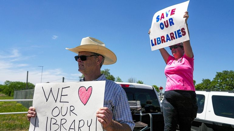 Michael McDavid and Emily Decker protest outside the Llano County...