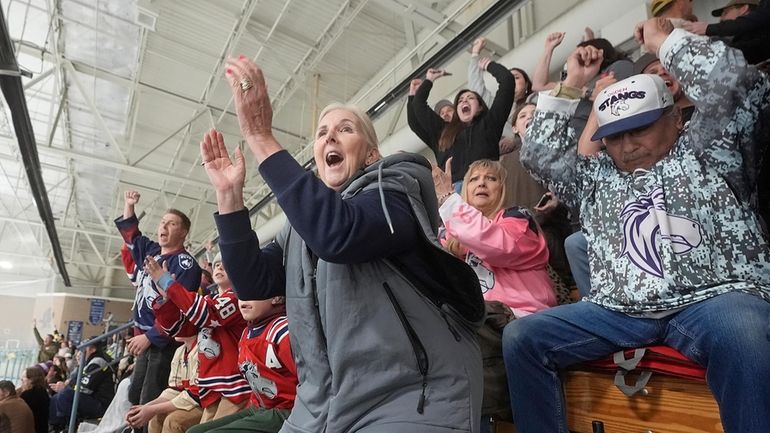 Julie Brian, center, of Layton, Utah, celebrates as the Ogden...