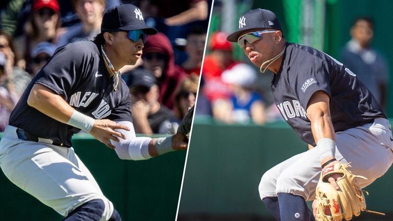 Yankees infielders Oswaldo Cabrera and Oswald Peraza field balls during spring...