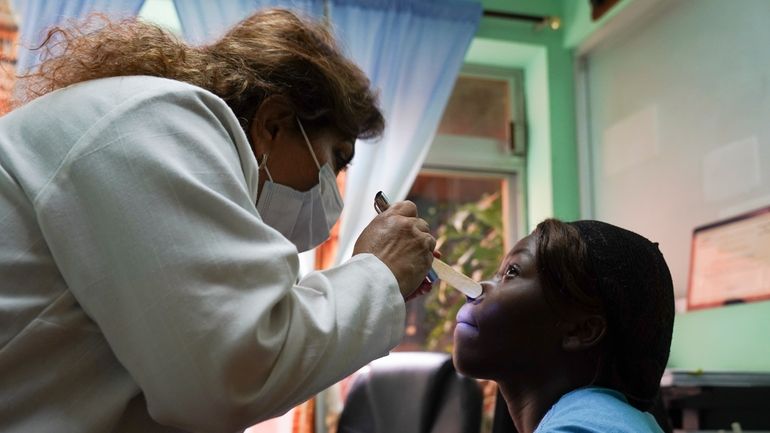 Dr. Sarahí Hernández Pacheco attends to Haitian Bellantta Lubin, at...