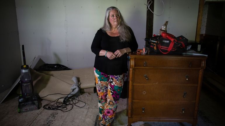 Lisa Edson-Neveu, 52 poses for a portrait at her house...