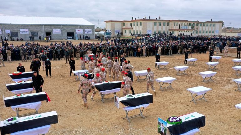 Mourners prepare to bury the remains of Yazidi victims in...