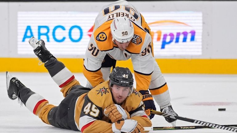 Nashville Predators center Ryan O'Reilly (90) falls on Vegas Golden...