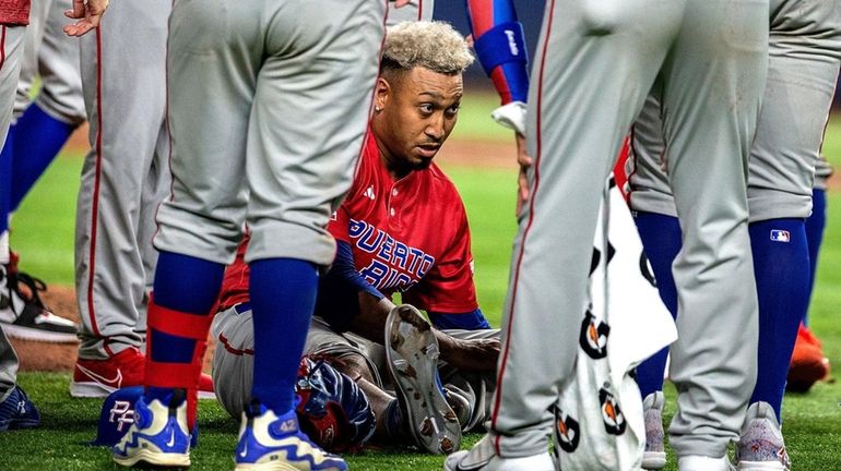 Edwin Diaz sits after getting injured after a World Baseball Classic...