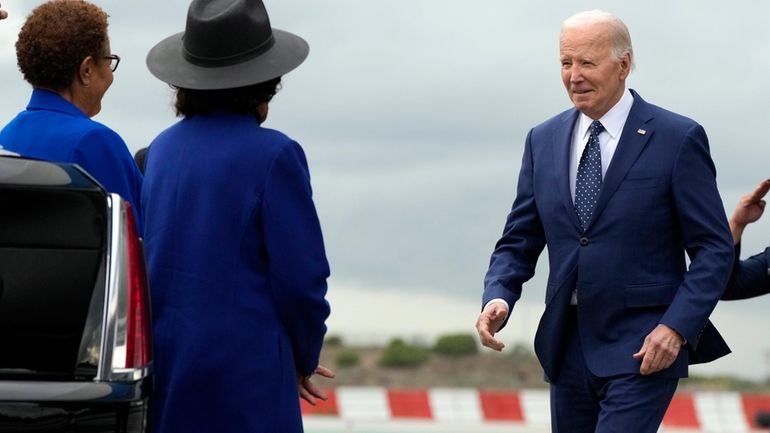 President Joe Biden greets Los Angeles Mayor Karen Bass, left,...