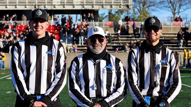 Marc Negrin is flanked by his two sons at Saturday’s...