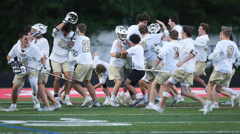 Bayport-Blue Point celebrates winning the Long Island Class C boys...