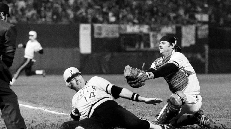 Pittsburgh Pirates' Ed Ott slides across home late out of...