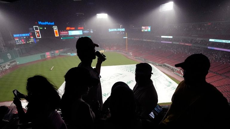 Fans wait out a rain delay during the second inning...